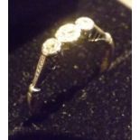 A three stone platinum and 18 carat gold ring, Three brilliant cut diamonds set in gold and