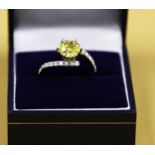 A Sinlge Yellow diamond soltiare ring, set in a diamond encrusted white gold twist style ring. The
