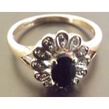 A saphire and diamond ring, A single stone sapphire ring suuround by illusion set diamonds, set in 9