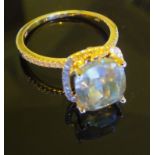 A 4.06 carat Cushion cut diamond, set in yellow gold Halo setting surrounded by diamonds.