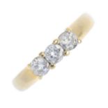 An 18ct gold diamond three-stone ring. The brilliant-cut diamonds, to the tapered band. Estimated