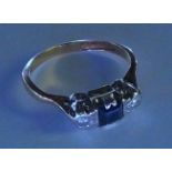 An 18ct gold and Platinum, Sapphire and diamond ring. One square cut sapphire set between 2 briliant