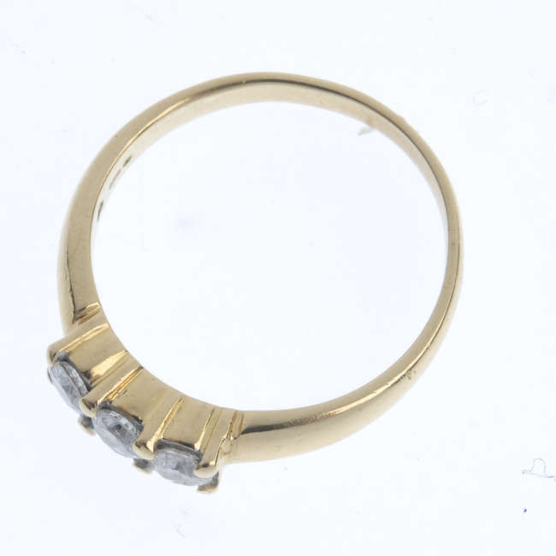 An 18ct gold diamond three-stone ring. The brilliant-cut diamonds, to the tapered band. Estimated - Image 2 of 3