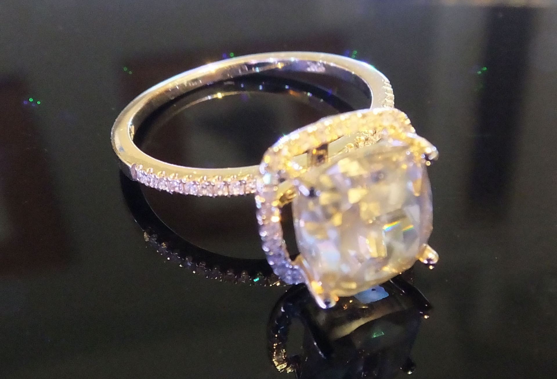 A 4.06 carat Cushion cut diamond, set in yellow gold Halo setting surrounded by diamonds. - Image 2 of 3