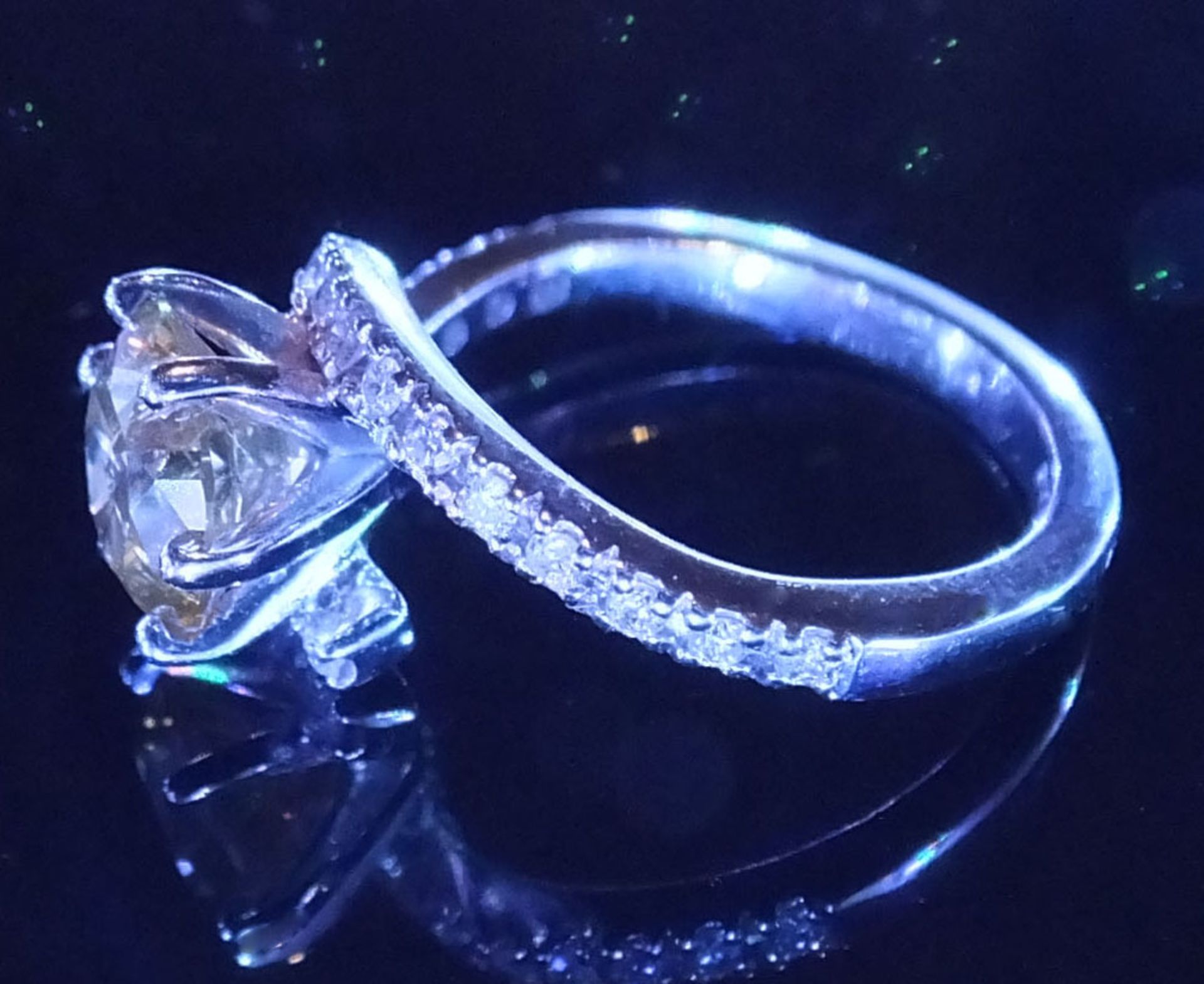 A Sinlge Yellow diamond soltiare ring, set in a diamond encrusted white gold twist style ring. The - Image 2 of 3