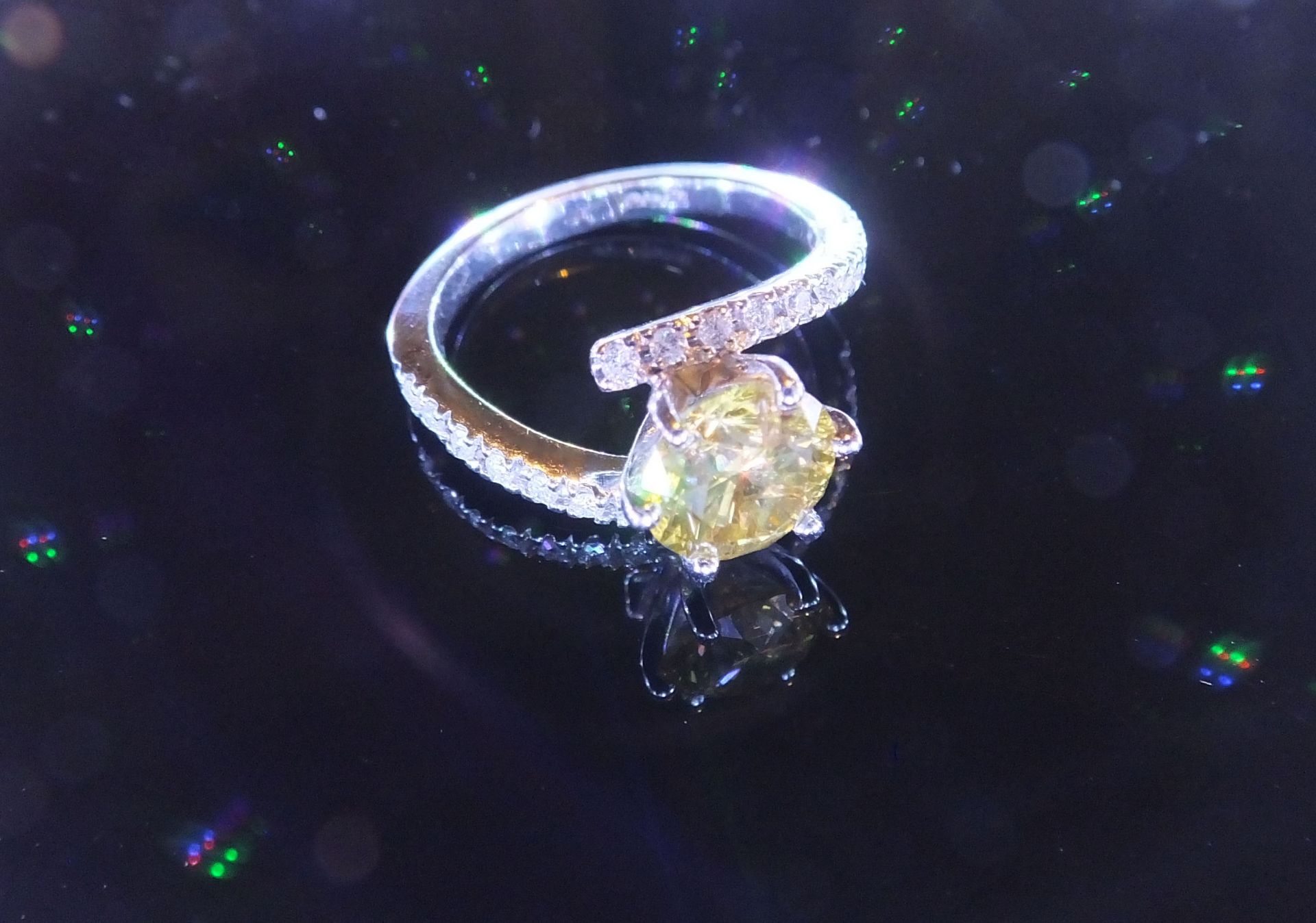 A Sinlge Yellow diamond soltiare ring, set in a diamond encrusted white gold twist style ring. The - Image 3 of 3