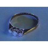 A 9ct gold diamond three-stone ring. The brilliant-cut diamonds, to the tapered band. Estimated