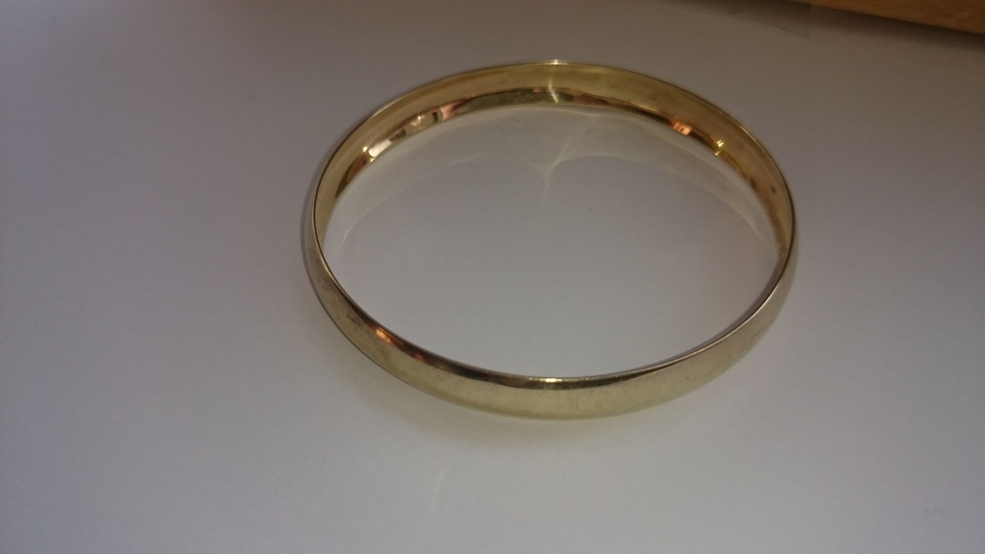 9ct solid hand made gold bangle.The bangle is domed and is 8.2mm wide. The bangle tests 9ct.