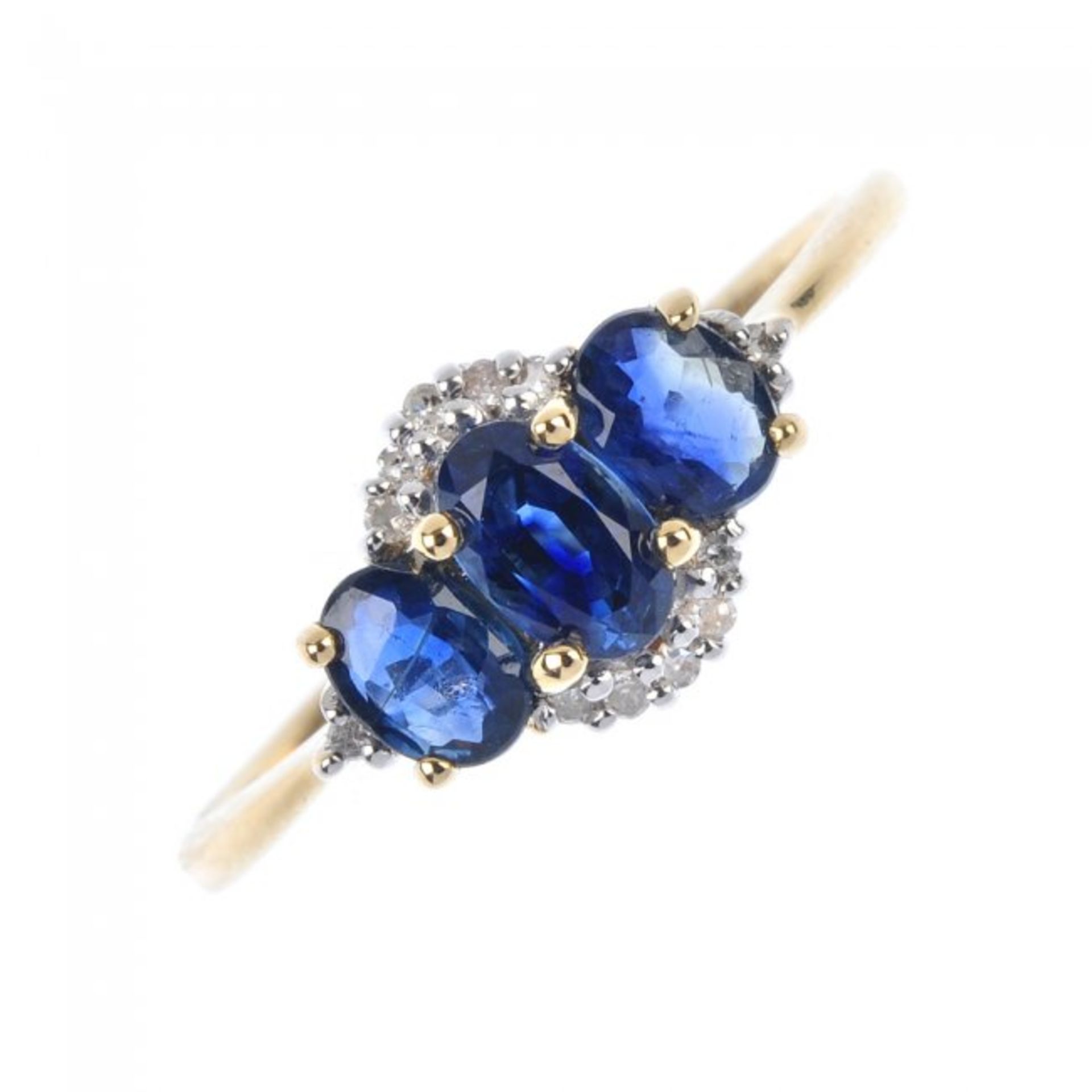 An 18ct gold sapphire and diamond three-stone ring. The slightly graduated oval-shape sapphire line,