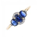 An 18ct gold sapphire and diamond three-stone ring. The slightly graduated oval-shape sapphire line,