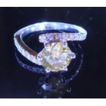 A Sinlge Yellow diamond soltiare ring, set in a diamond encrusted white gold twist style ring. The