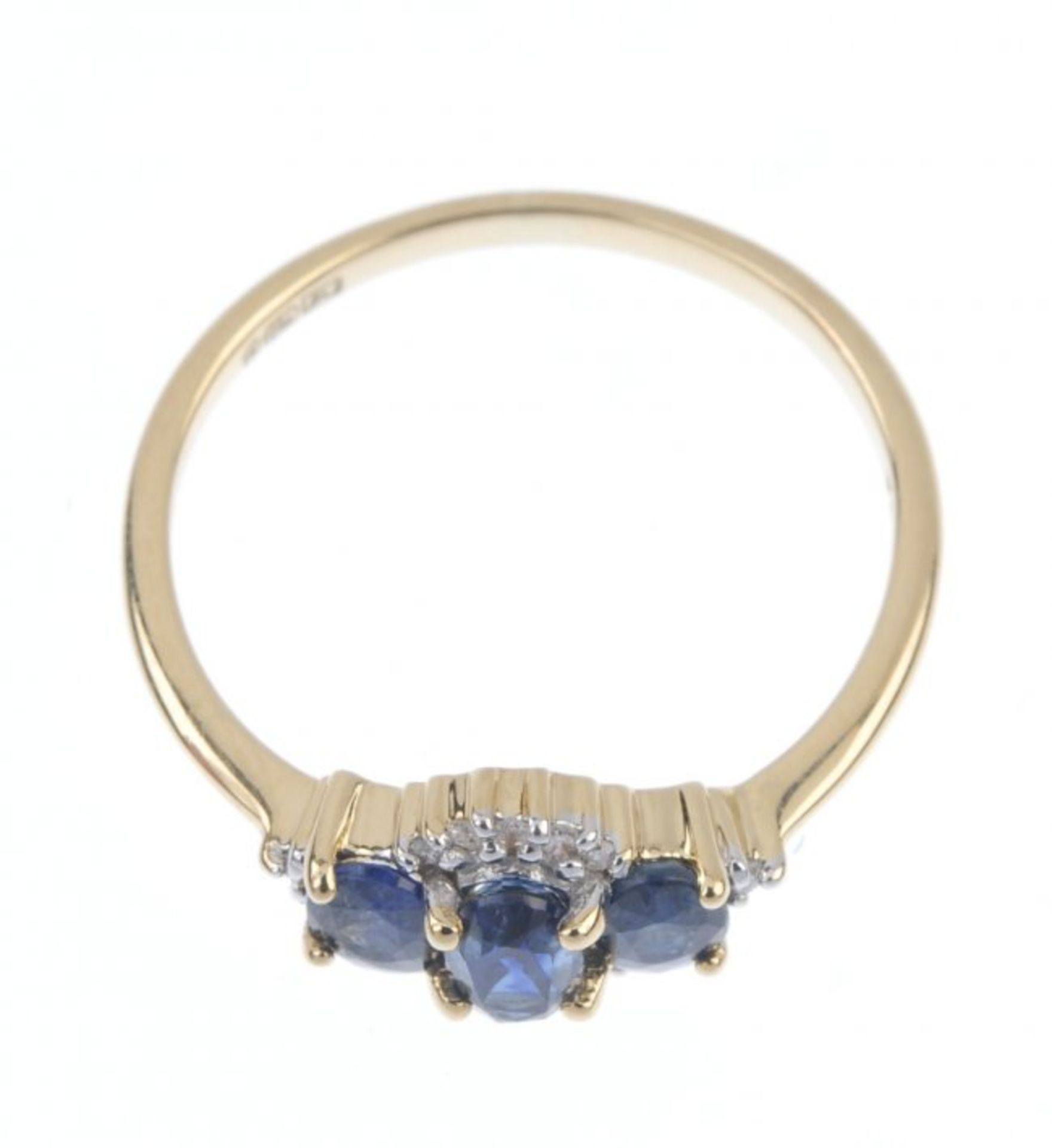 An 18ct gold sapphire and diamond three-stone ring. The slightly graduated oval-shape sapphire line, - Image 2 of 2