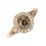 A coloured diamond and diamond cluster ring. The old-cut 'brown' diamond, within a rose-cut