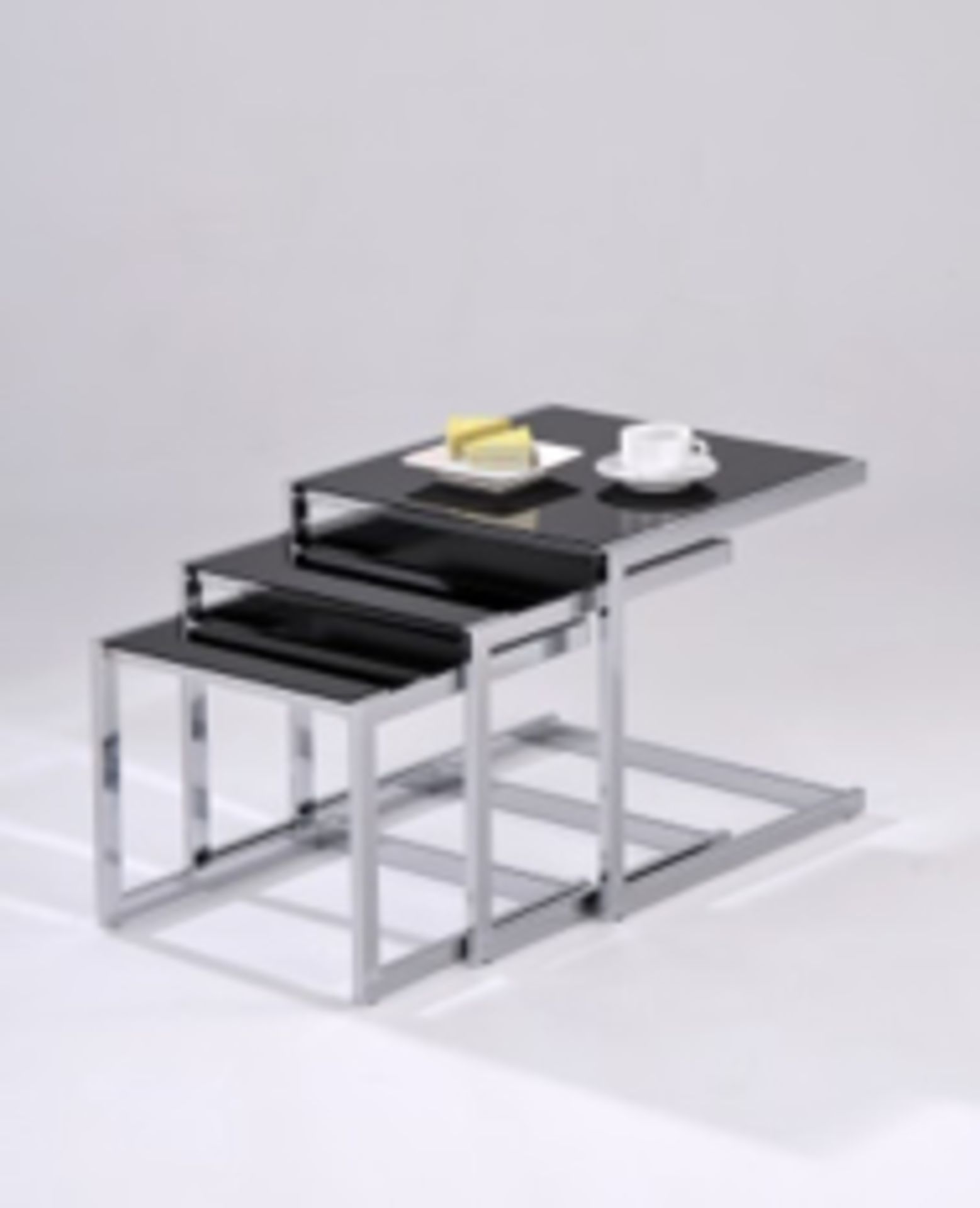 A very high quality nest of tables. Polished and finished in chrome with black glass