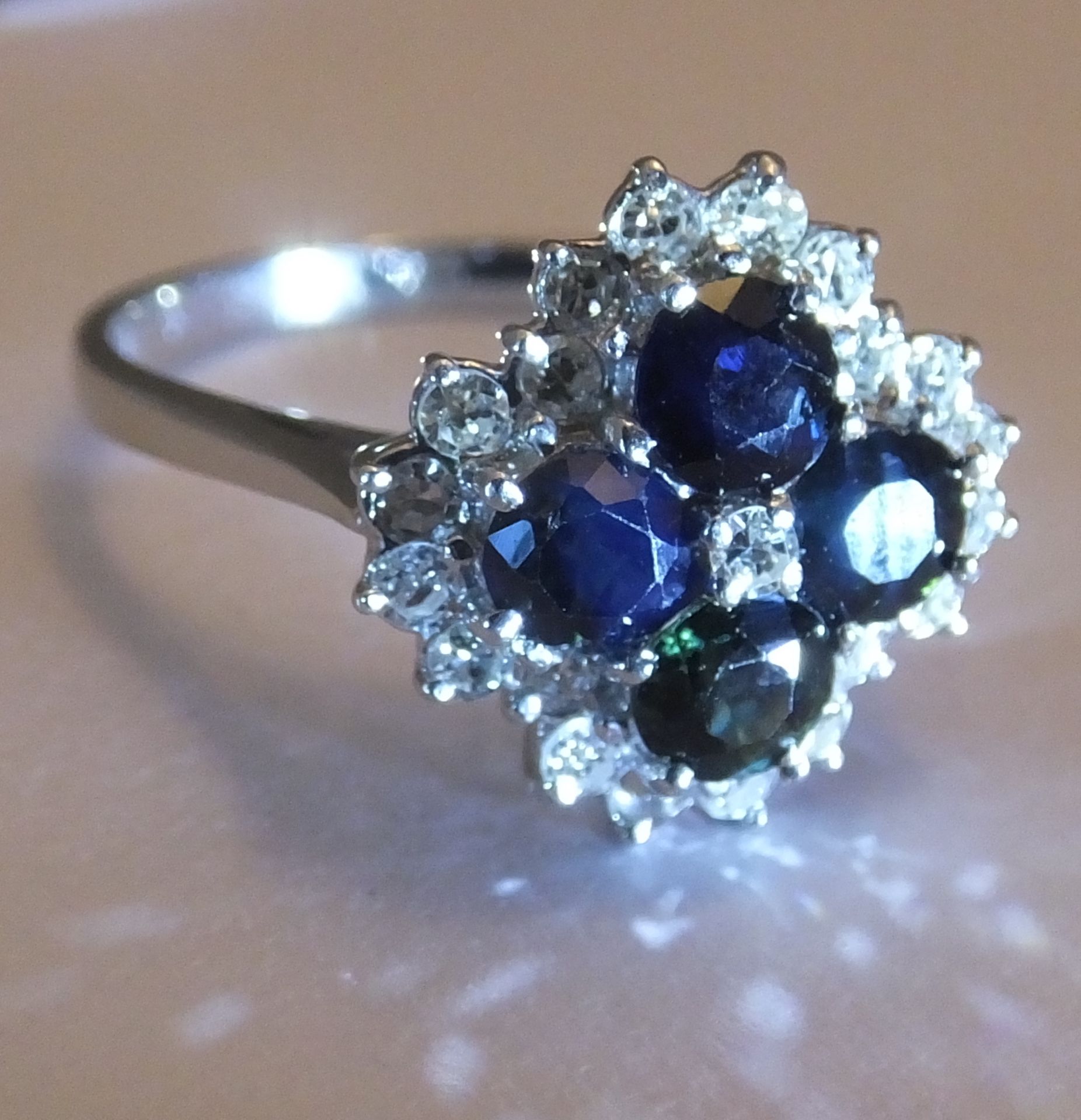 An 18ct gold sapphire and diamond cluster ring. Size O. The single-cut diamond, within a circular- - Image 3 of 3