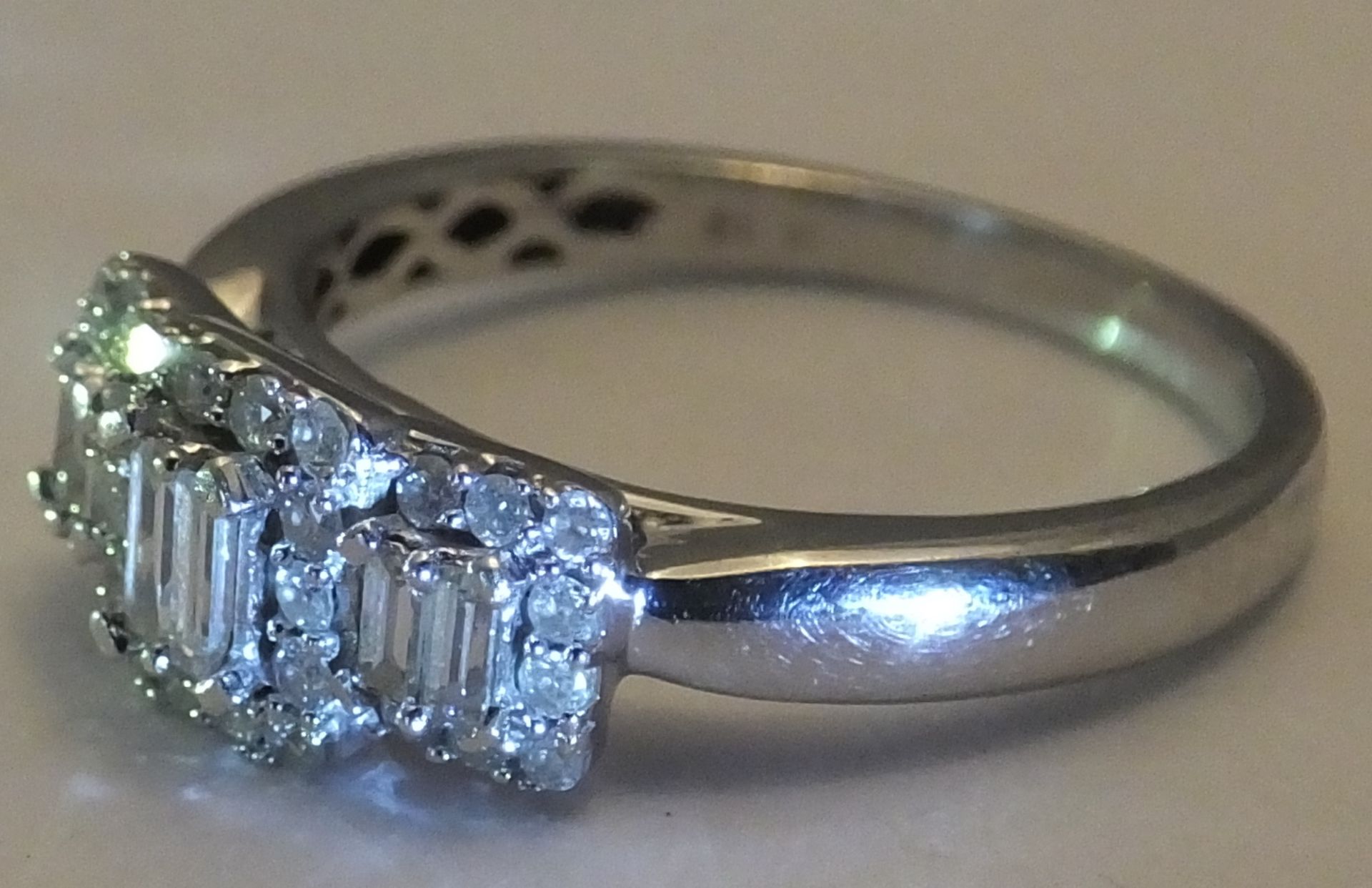 A White gold diamond ring - Size 0. Designed as two baguette-cut diamonds within a brilliant-cut - Image 2 of 3