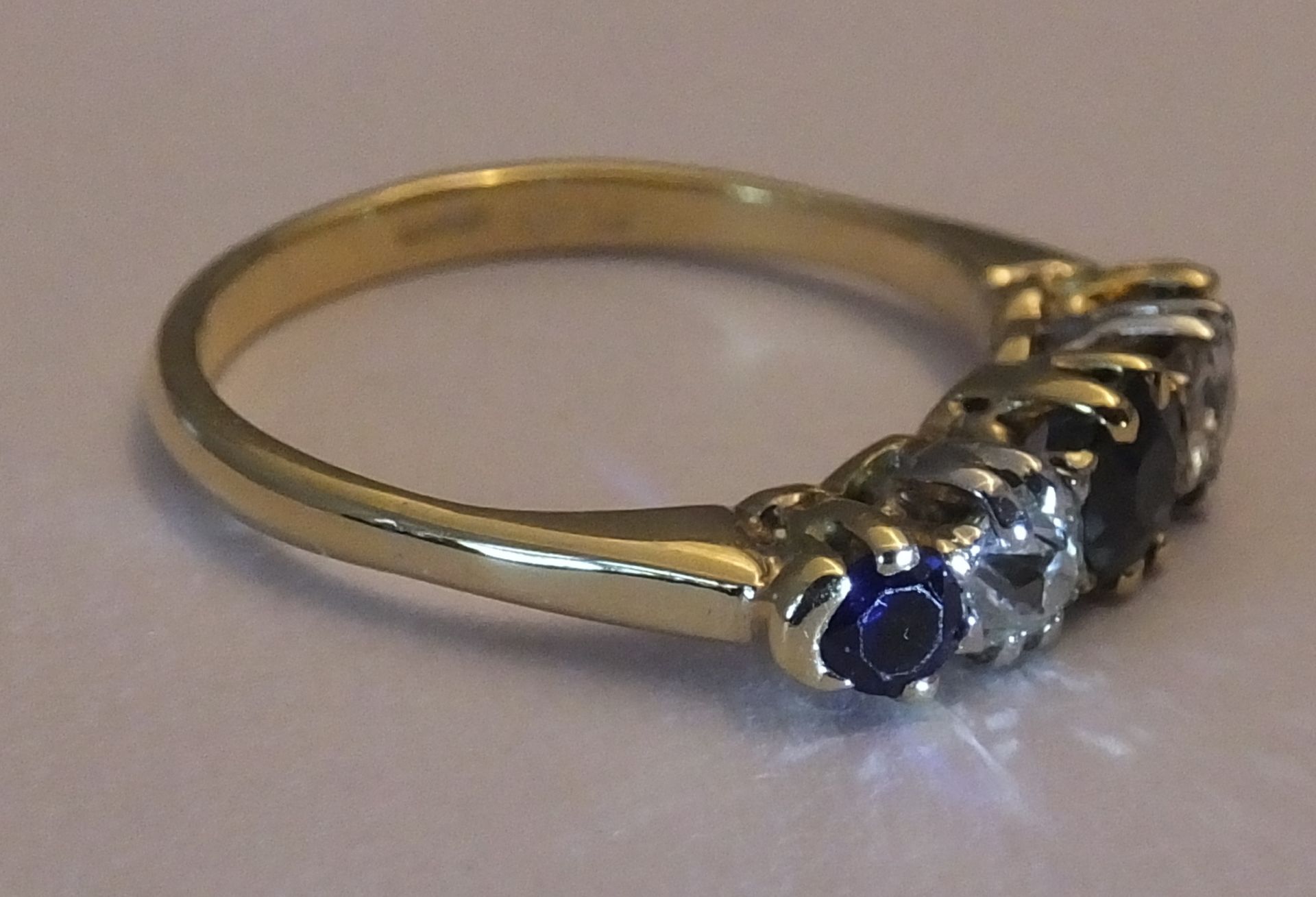 A mid 20th century 18ct gold sapphire and diamond five-stone ring. Size L. The circular-shape - Image 3 of 3