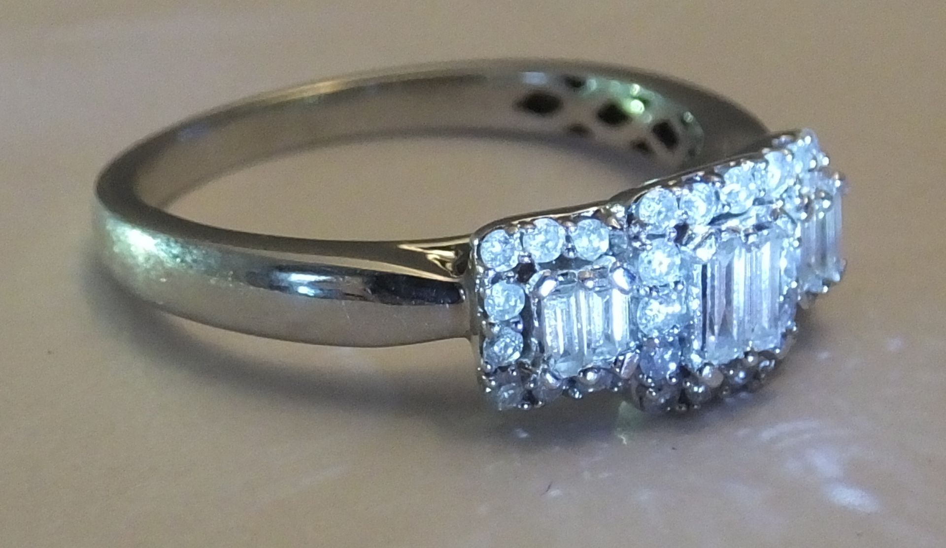 A White gold diamond ring - Size 0. Designed as two baguette-cut diamonds within a brilliant-cut - Image 3 of 3