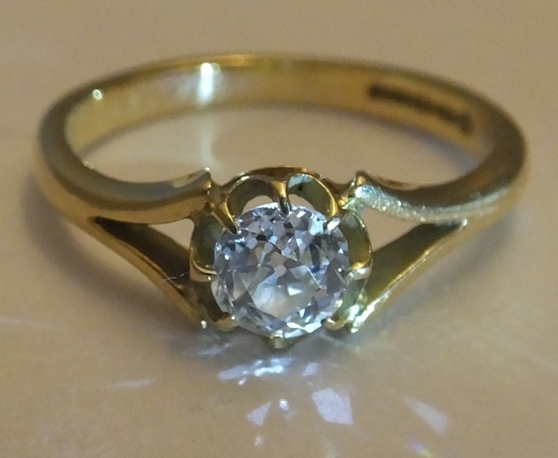 An 18ct Diamond Ring. Size K. An old mine cut diamond of around 0.33 carat this old mine cut ring