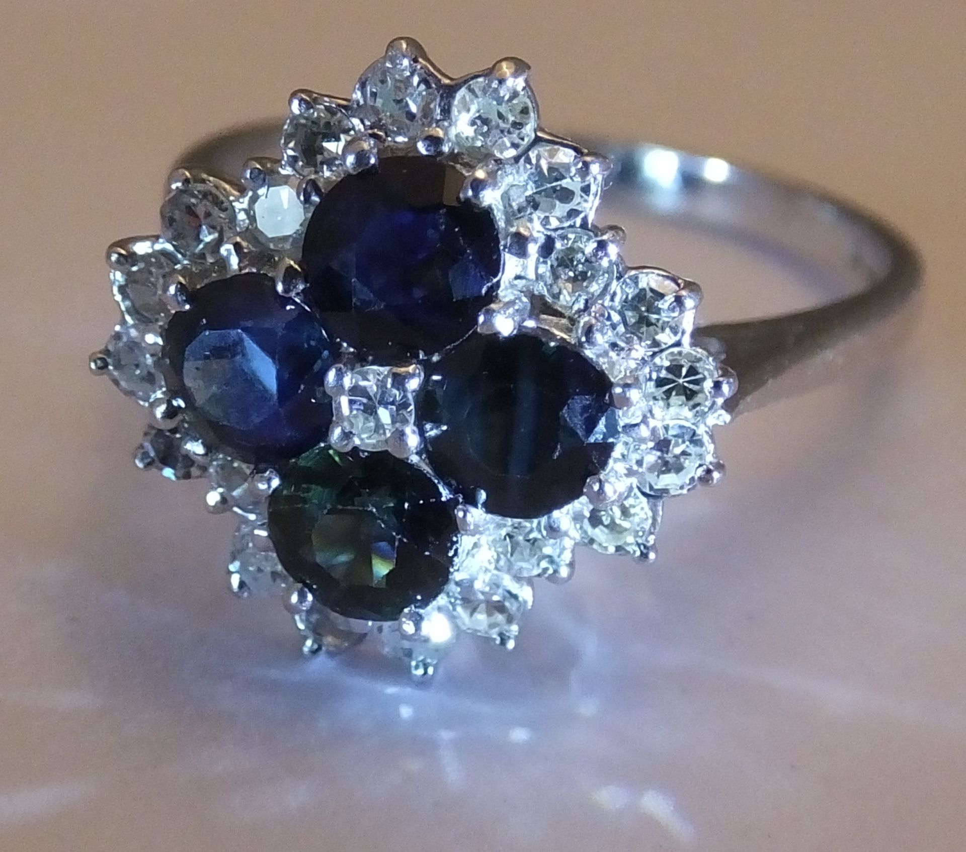 An 18ct gold sapphire and diamond cluster ring. Size O. The single-cut diamond, within a circular- - Image 2 of 3