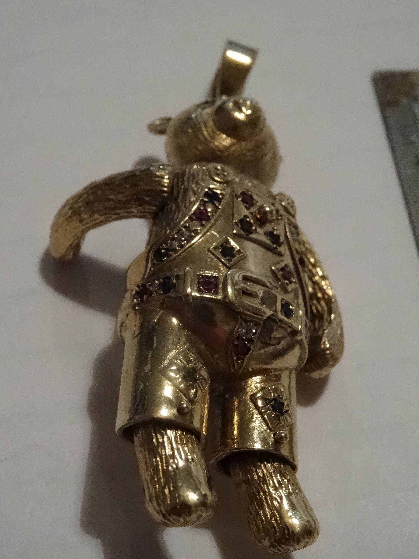 9 Carat Yellow Gold Moveable Teddy Bear Pendant. Set with 26 Stones in green, clear, red and blue. - Image 3 of 3