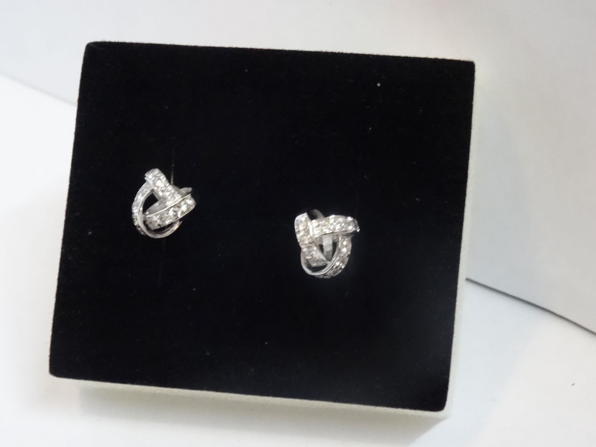 9 Carat White Gold Pair of Cubic Zirconia Twist Knot Design Earrings.