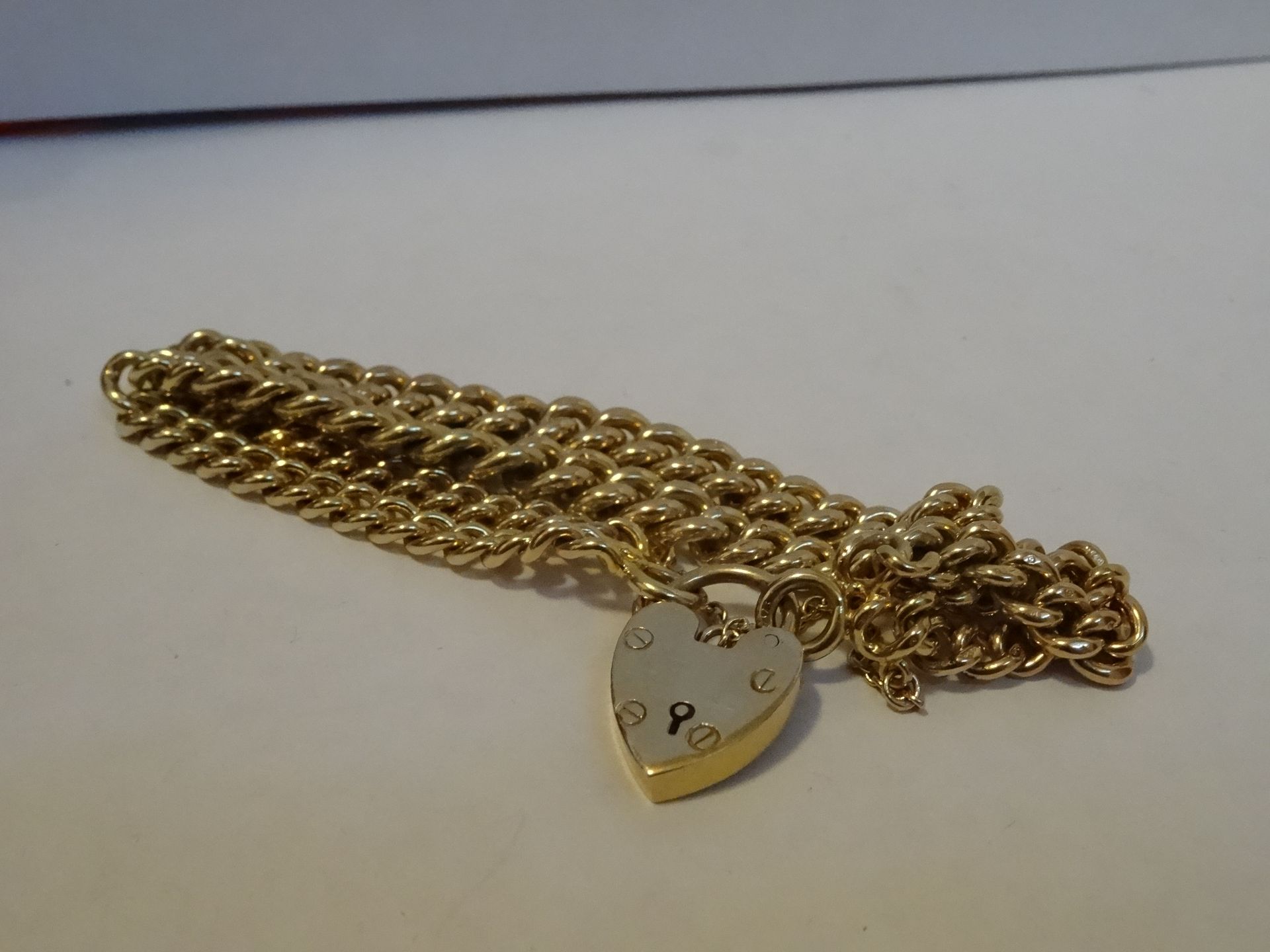 9 Carat Yellow Gold Curb Style Bracelet, with heart lock clasp.