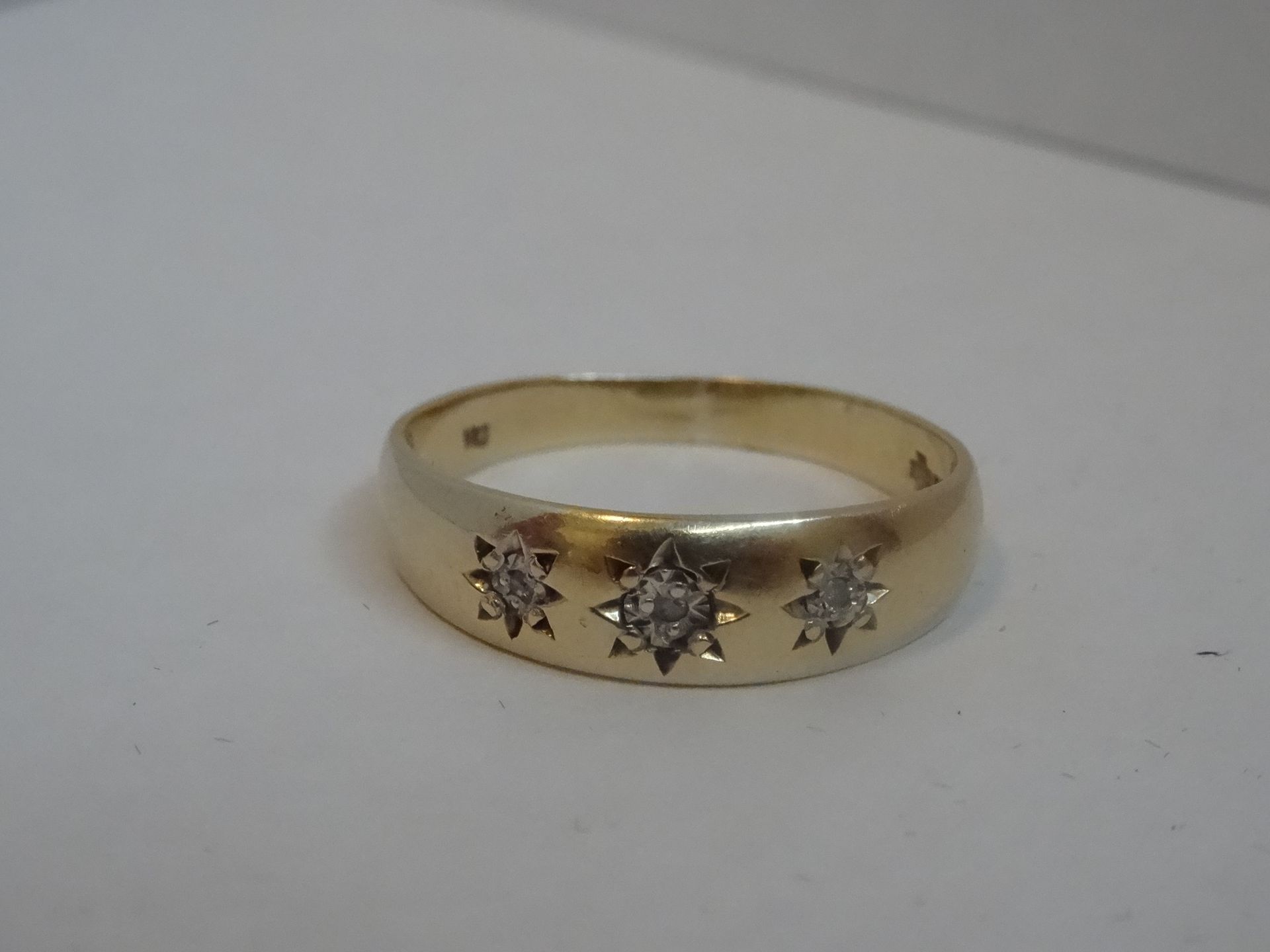 9 Carat Gold Diamond Band Ring Set with 3 Diamonds. Total Piece Weight 2.49 Grams