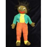 An early Merrythought velvet faced, button eyed gollywog and integral multi coloured outfit with