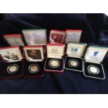 Nine boxed silver proof fifty pence pieces from the Royal Mint all with COA and celebrating