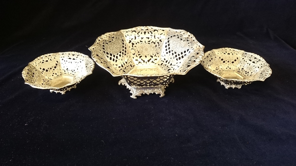 Set of three white metal bon bon dishes