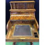 An antique Burr Walnut Davenport and features the beautiful original tooled and gilded leather