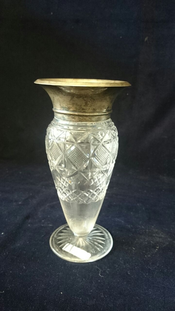 A glass vase with silver top hallmarked Birmingham 1922