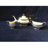 A silverplated teapot along with a silver sugar bowl and milk jug Hallmarked London 1965 Silver