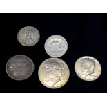 One silver dollar and four silver half dollars