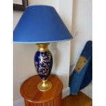 A pair of large gold and blue table lamps.