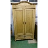 Antique styled pine wardrobe/armoire with drawer under and serpentine top.