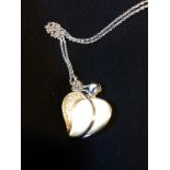 A silver heart necklace and pendant