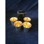 Set of four silver shot glasses in a leather travel case