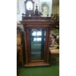 Walnut display cabinet c19c/20c with key galleried top with carved mask and turned finials, glazed