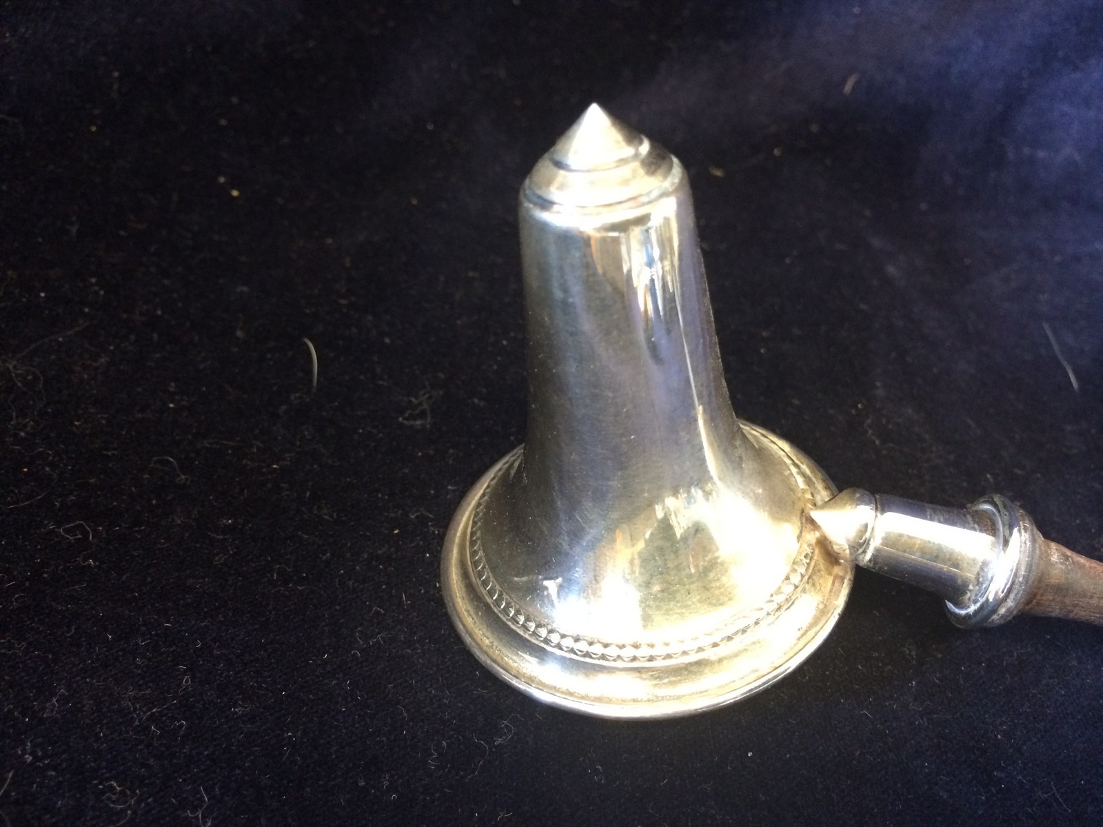 A silver with wodden handled candle snuffer