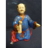 Canton enamel kneeling man in rich blue and red robes and with the head and hands in one of which is