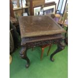 An oriental table with carved legs