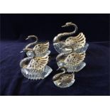 A selection of decorative glass and silver swans