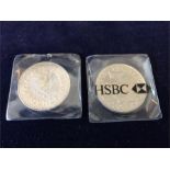 A pair of Millenium five pound coins