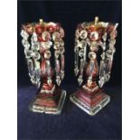 A pair of cranberry and cut glass candlestick/lamp bases