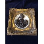A Bronze and stone plaque featuring cherubs