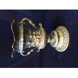 An antique bronze urn 27cms high.