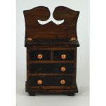 A late 19th/early 20th Century carved wooden apprentice model of a chest of drawers
The two short