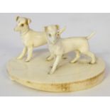 A Continental carved ivory figure group of two dogs, possibly German
Mounted on a carved ivory